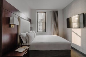 Premium bedding, desk, laptop workspace, blackout drapes