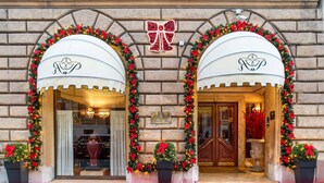A hotel entrance with two arched doorways, each adorned with a bow and festive garlands. - River Palace Hotel (Rome)
