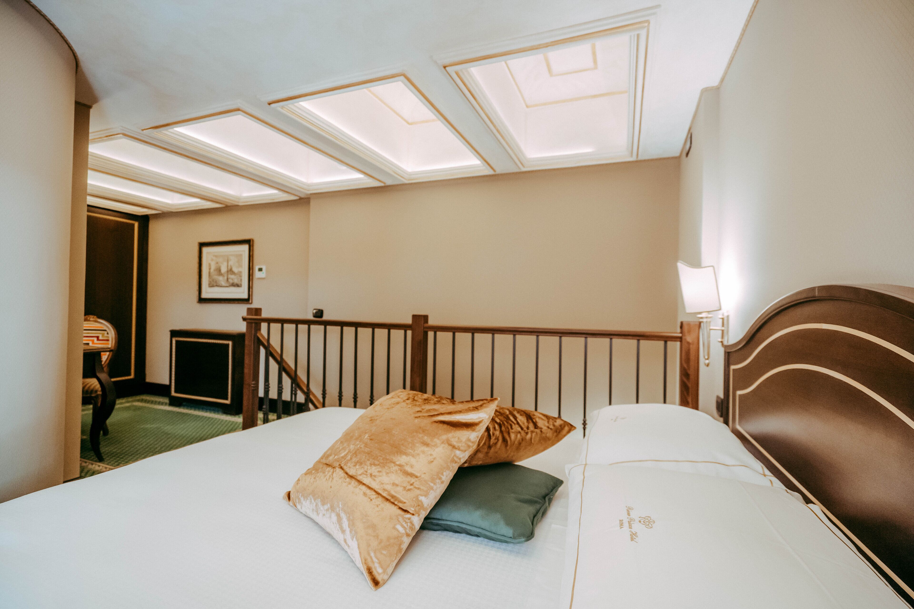 A hotel room with a bed, a desk, and a chair.