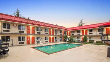 Guests can enjoy a tranquil stay with access to a central swimming pool and balconies.