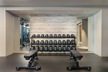 A modern bar area with leather seating, a bar counter, and a large screen. at The Westin New York at Times Square