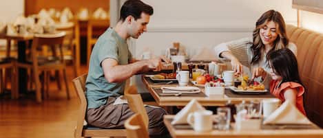 A couple dining at a restaurant with wooden furniture and a warm ambiance.