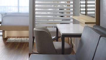 A modern room with a bed, a table, and a chair.