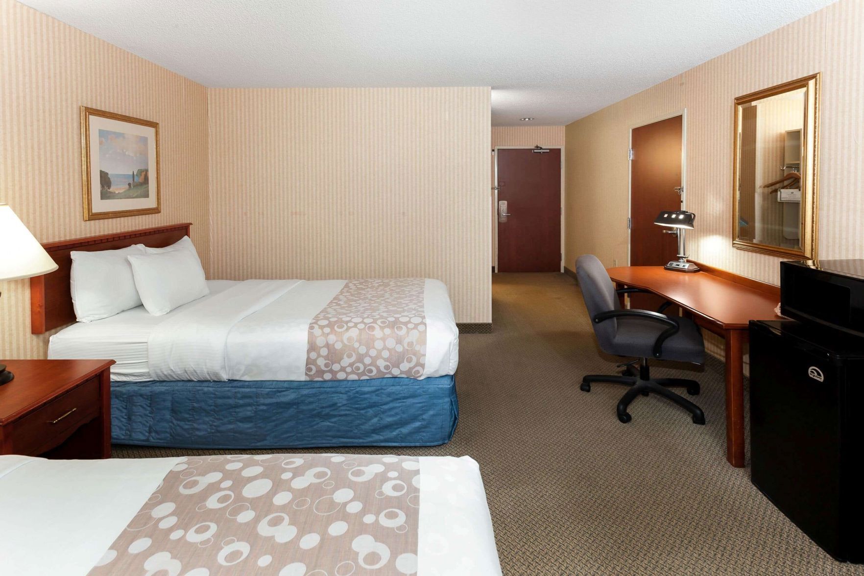 Premium bedding, desk, laptop workspace, blackout drapes