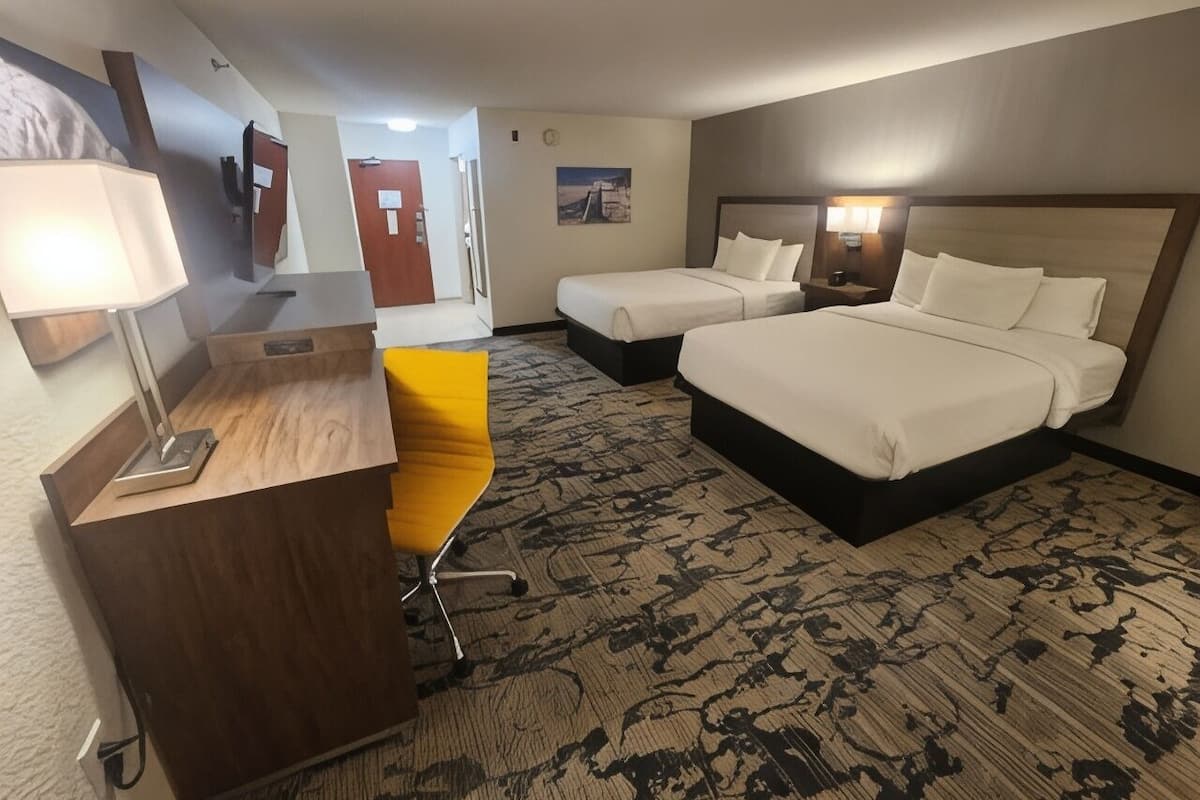 Premium bedding, desk, laptop workspace, blackout drapes
