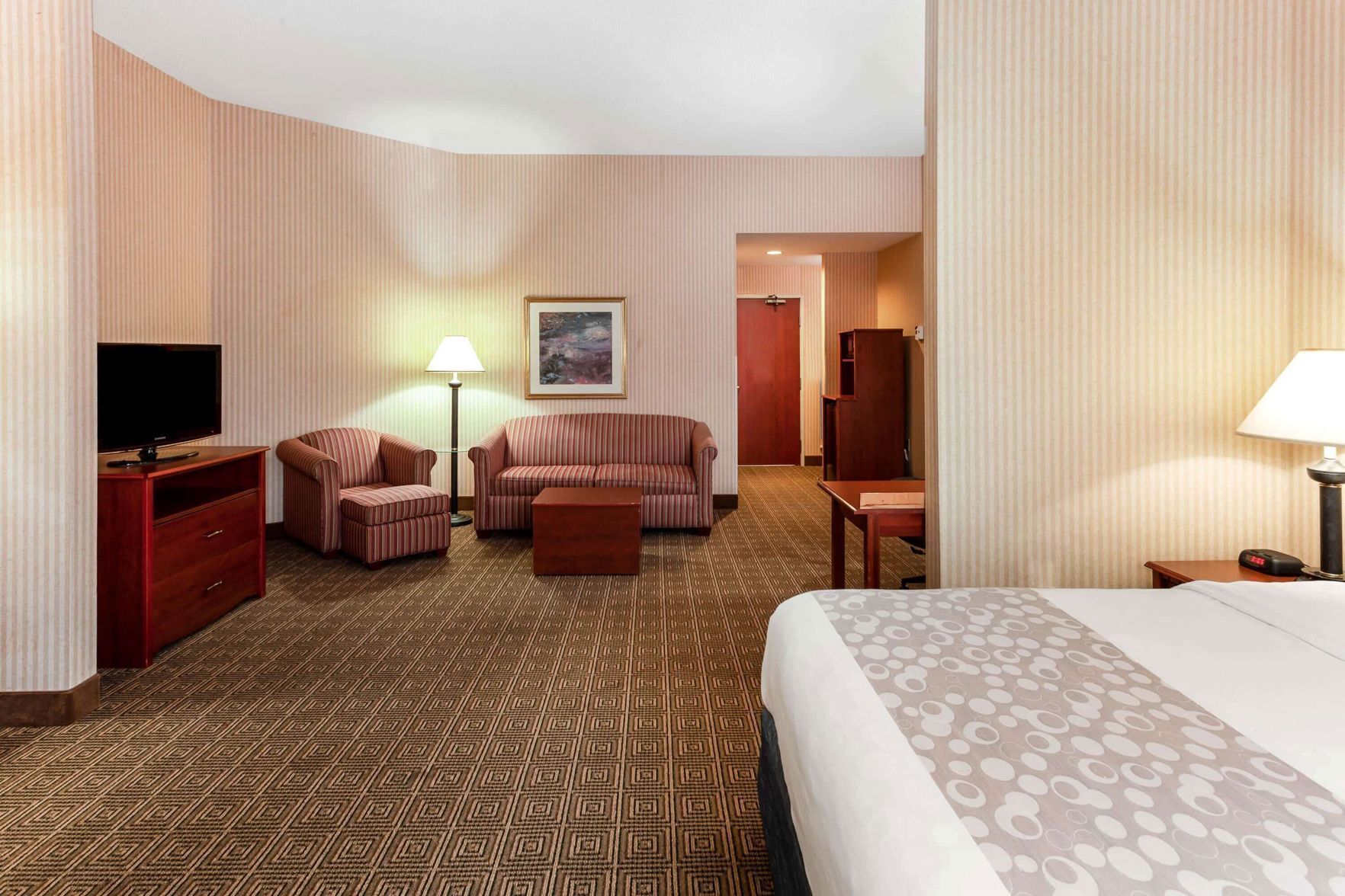 Premium bedding, desk, laptop workspace, blackout drapes