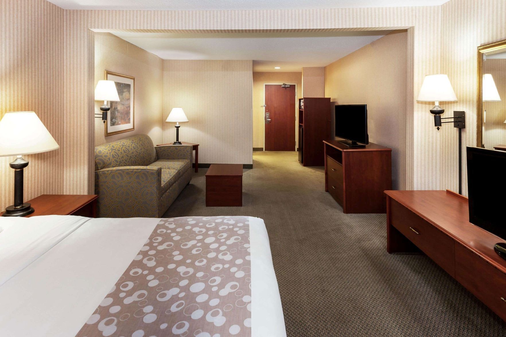 Premium bedding, desk, laptop workspace, blackout drapes