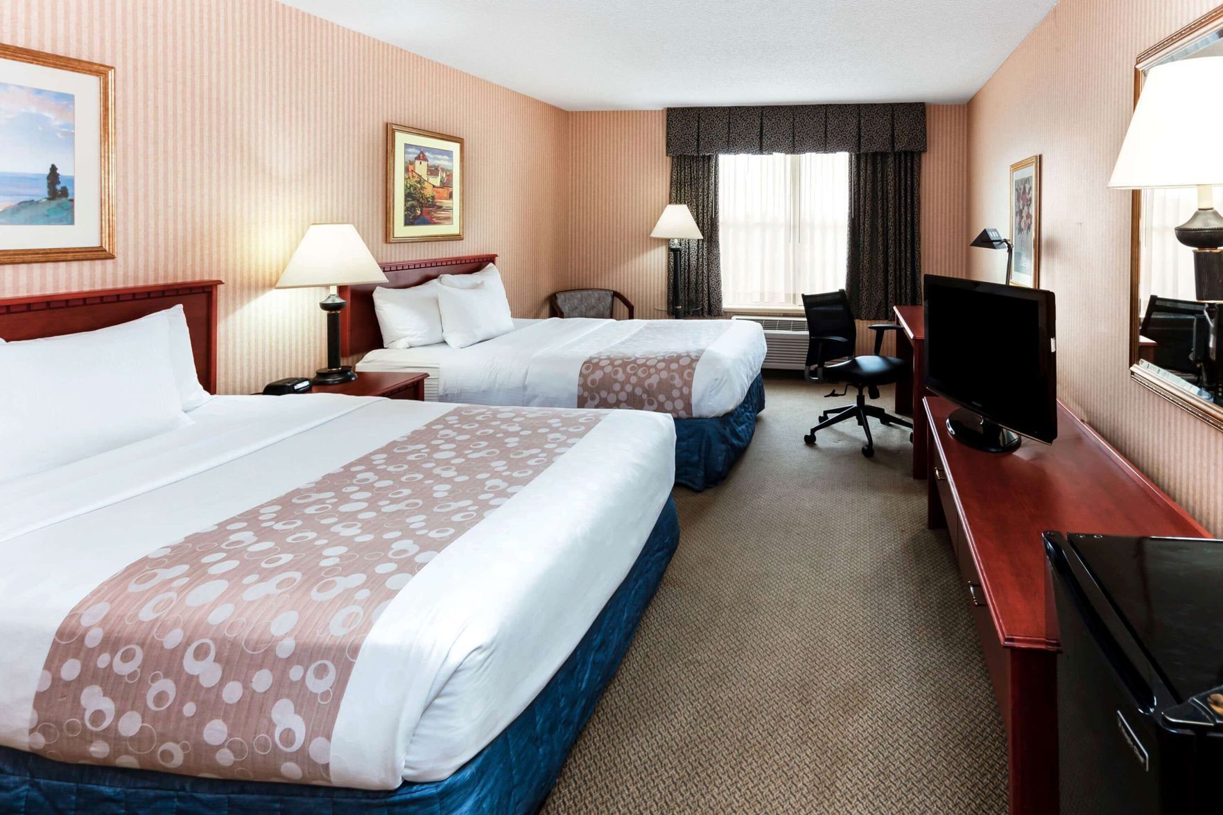 Premium bedding, desk, laptop workspace, blackout drapes