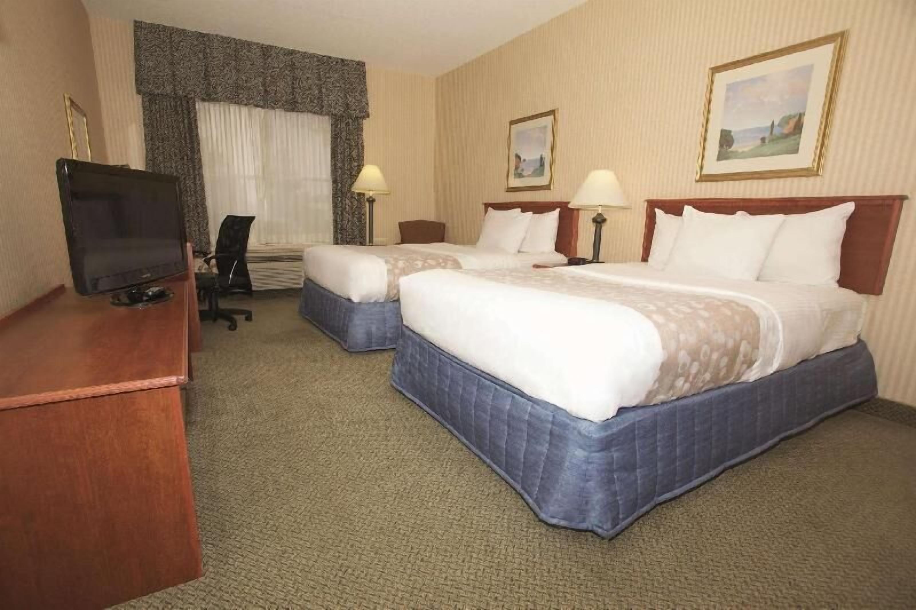 Premium bedding, desk, laptop workspace, blackout drapes
