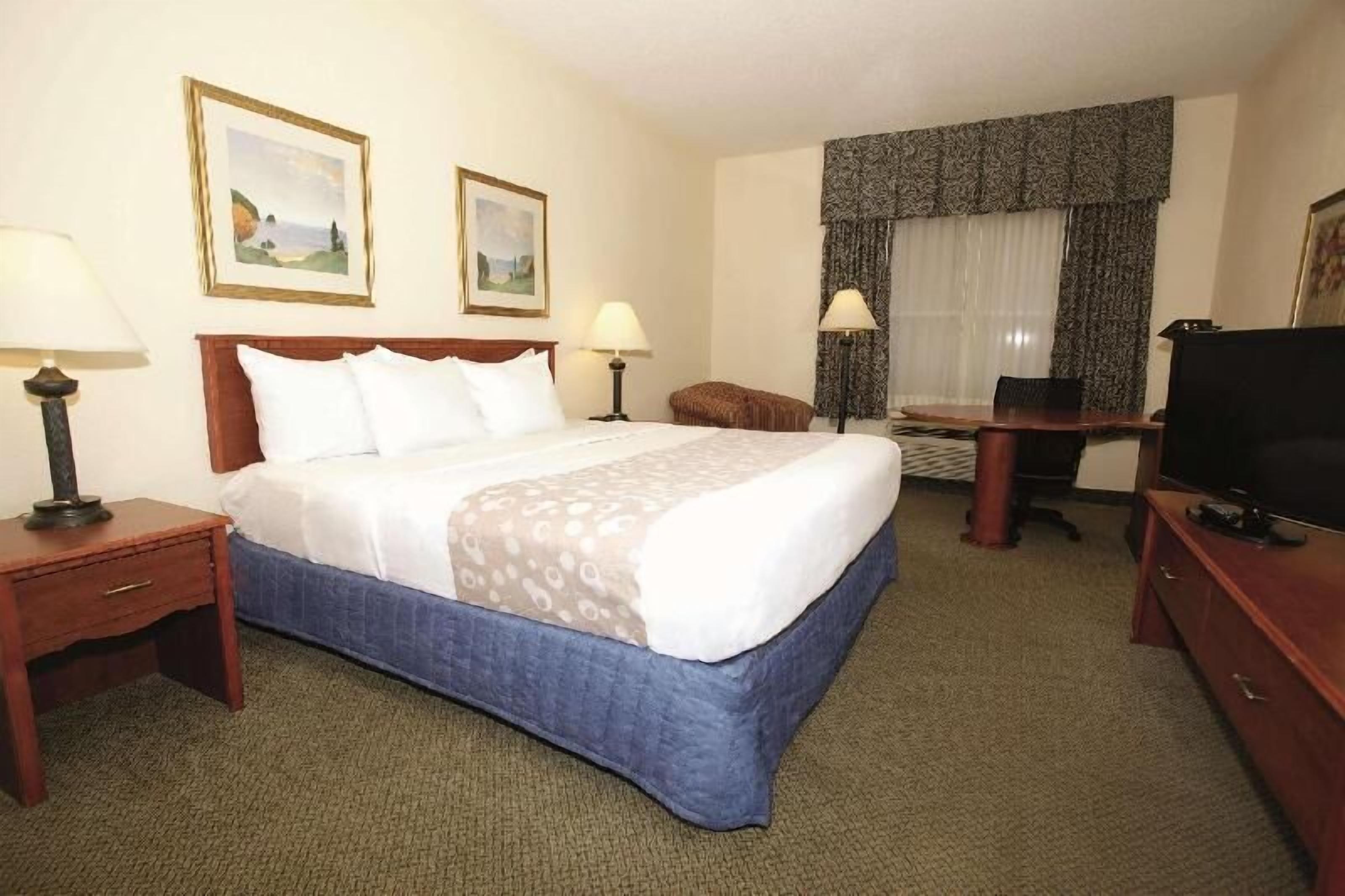 Premium bedding, desk, laptop workspace, blackout drapes