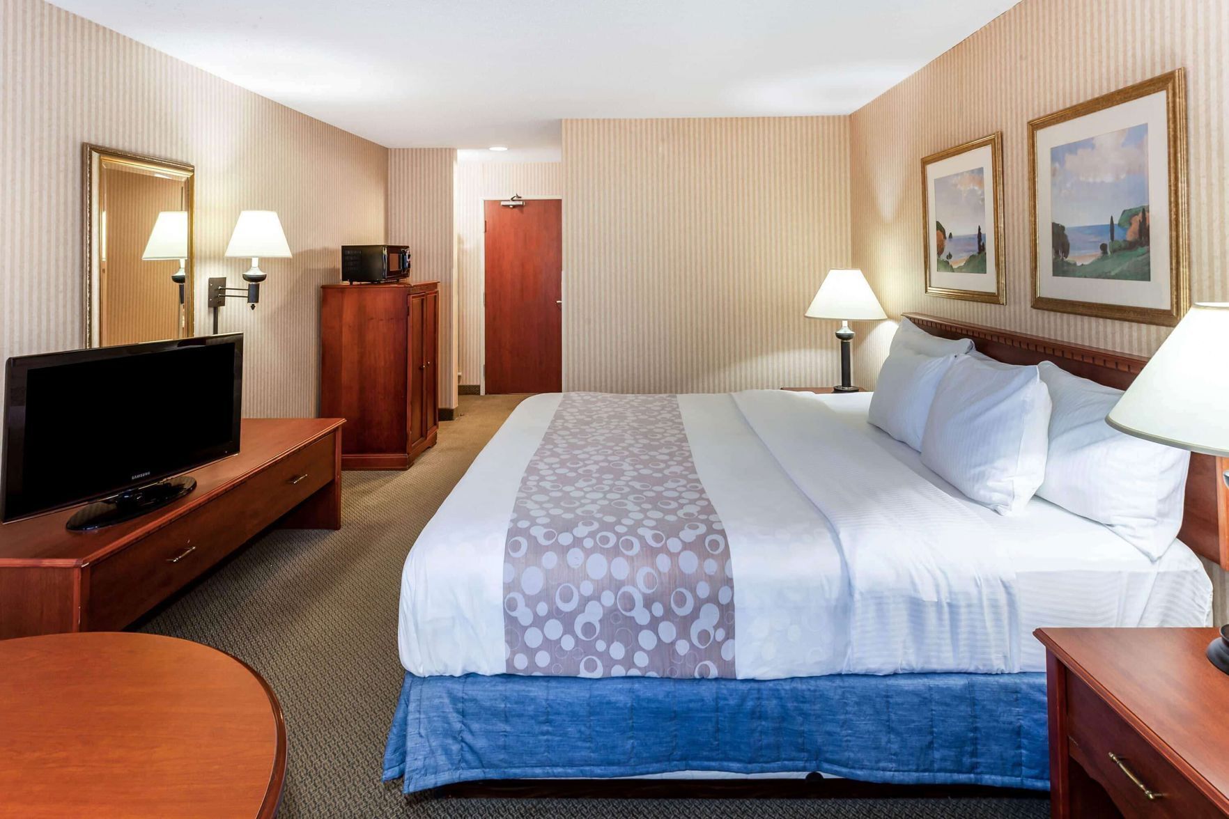 Premium bedding, desk, laptop workspace, blackout drapes
