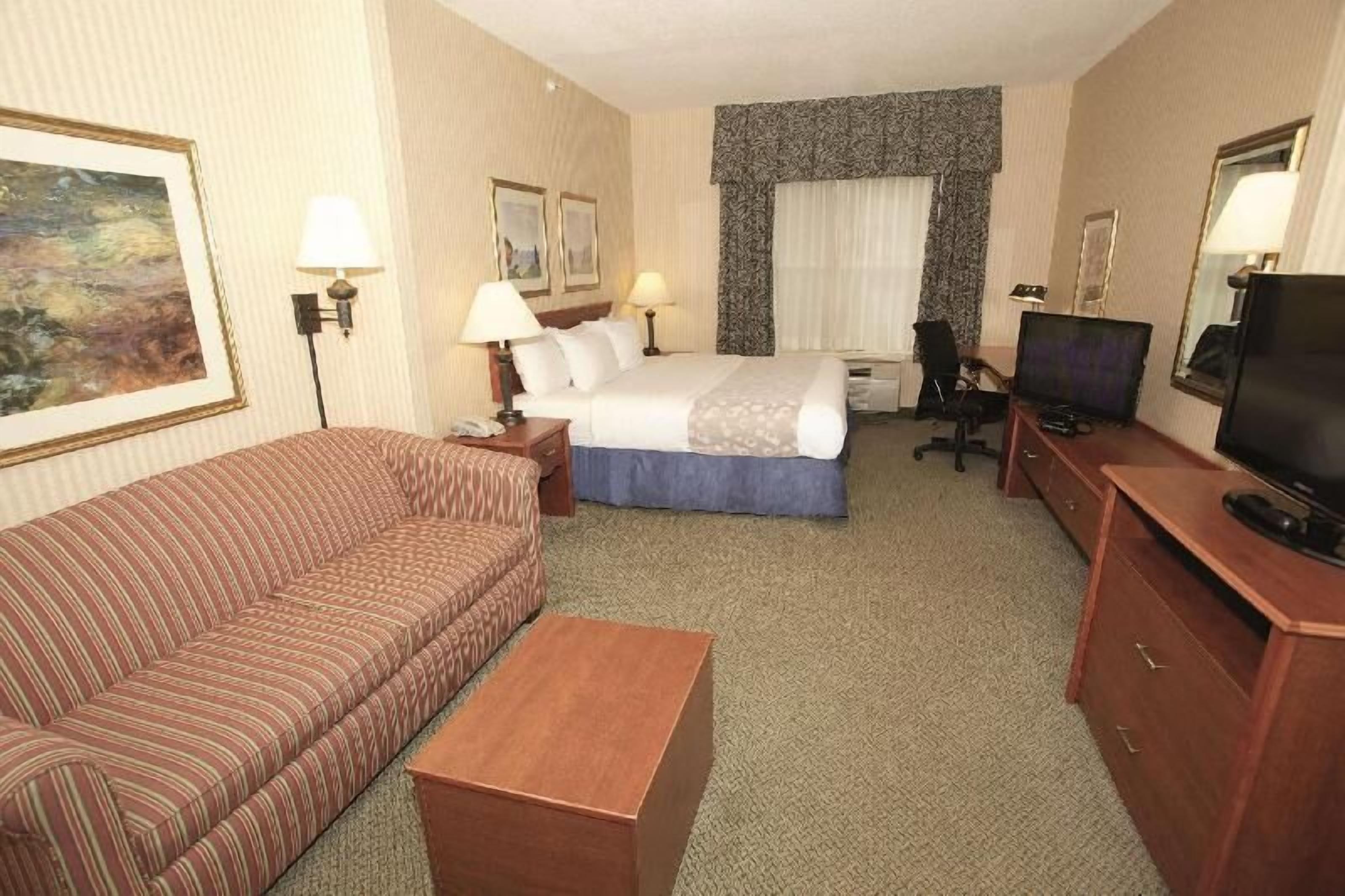 Premium bedding, desk, laptop workspace, blackout drapes