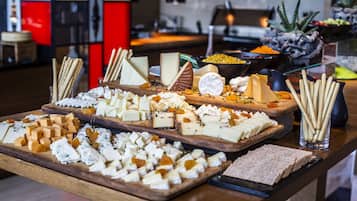 A cheese and cracker board with various cheeses and crackers.