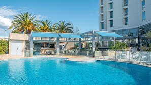 Seasonal outdoor pool, open 10:00 AM to 7:00 PM, pool umbrellas