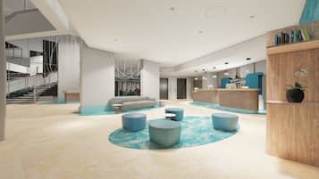 A spacious lobby with a reception desk, seating area, and a staircase.