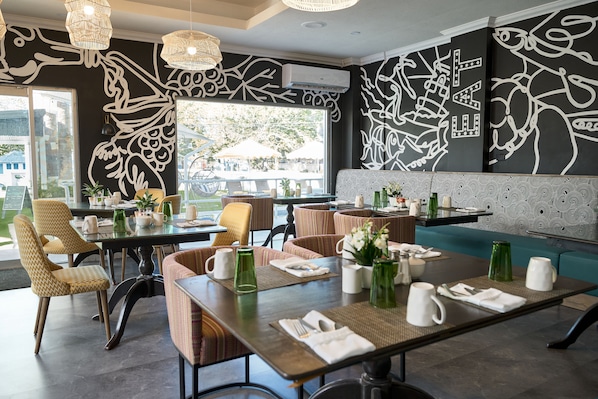 Enjoy a formal dining experience with comfortable seating and a contemporary art touch.