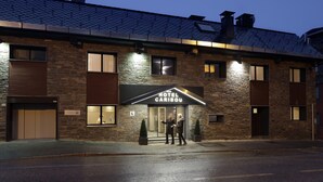 A hotel with a stone facade, a sign reading "HOTEL CARIBOU," and a modern design. - Hotel Caribou (Pas de la Casa)
