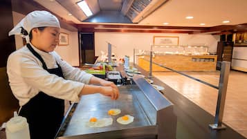 A chef preparing food on a grill in a restaurant.