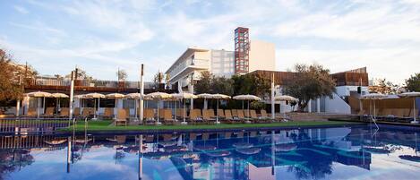 Seasonal outdoor pool, open 11:00 AM to 7:00 PM, pool umbrellas