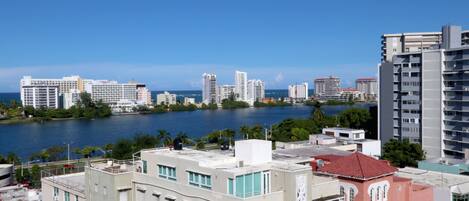 A coastal cityscape with high-rise buildings and a body of water.