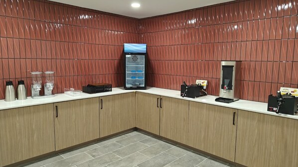 A modern kitchen area with a coffee machine, a waffle maker, and a refrigerator. - Hawthorn Extended Stay by Wyndham DFW Airport North (Irving)