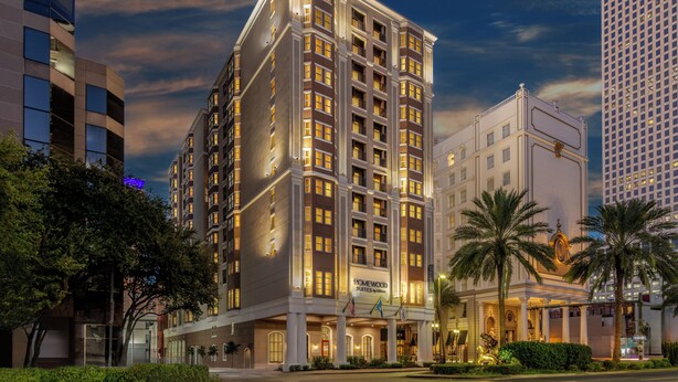 A multi-story hotel with a classic architectural design, featuring a prominent entrance with a large archway and a sign indicating it is a homewood suites hotel. - Homewood Suites by Hilton New Orleans (New Orleans)