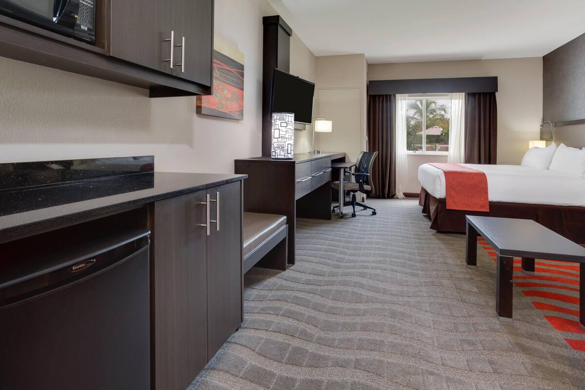 Premium bedding, desk, laptop workspace, blackout drapes