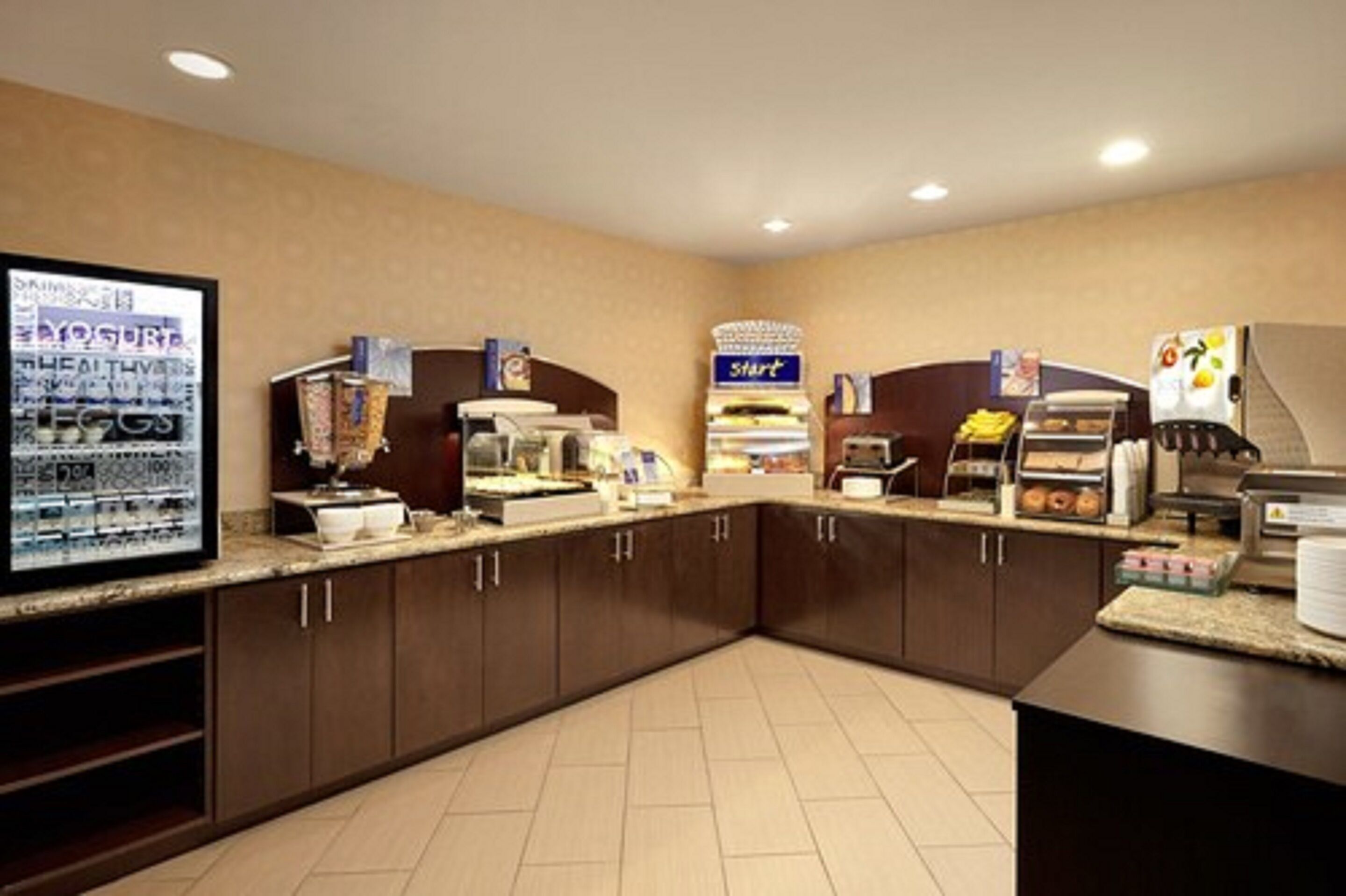 A breakfast area with a self-service station, a refrigerator, and a coffee machine.