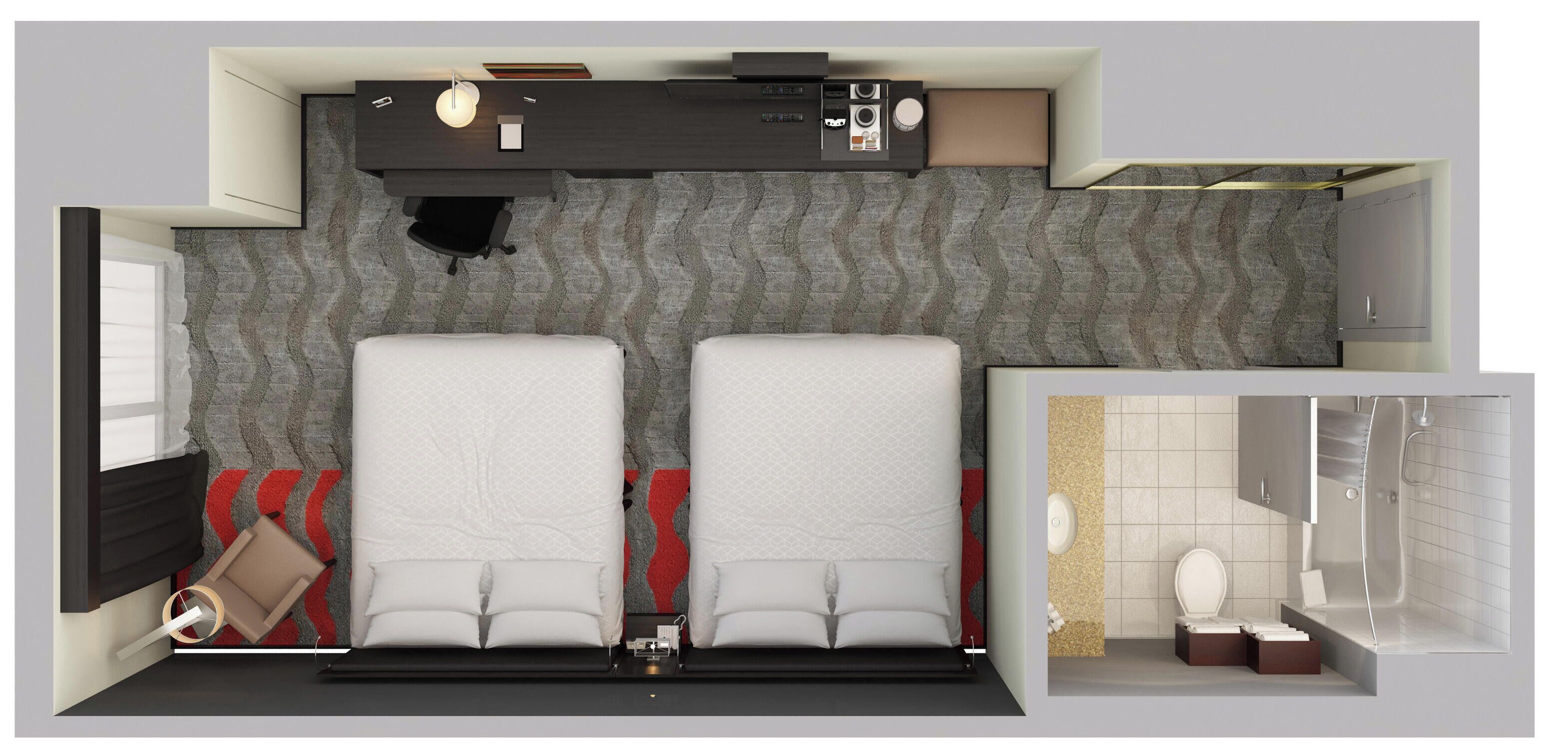 Une chambre d’hôtel moderne dotée d’un grand lit, d’un bureau avec un ordinateur, d’un petit coin salon et d’une salle de bain avec douche et toilettes.