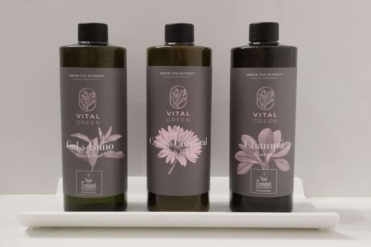 Three bottles of Vital Green products on a white shelf.