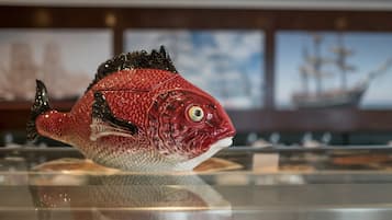 A fish-shaped sculpture on a reflective surface.