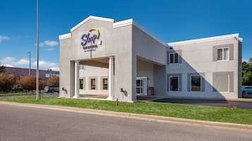 Welcome to Vincent Strokes by Chance Hotels, where guests can enjoy a comfortable stay in a contemporary building with a flat roof and rectangular windows.