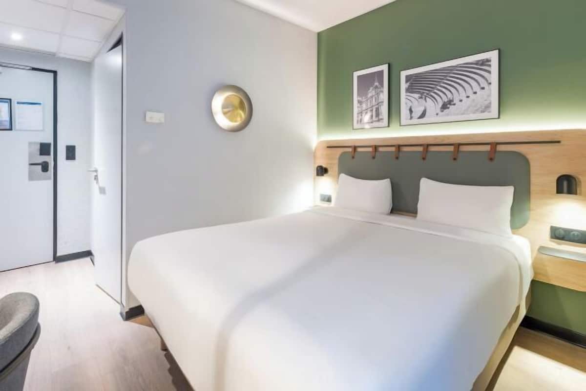 Premium bedding, desk, laptop workspace, blackout drapes