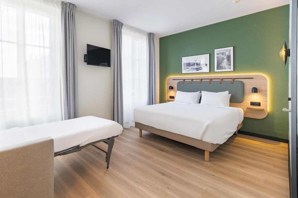 Premium bedding, desk, laptop workspace, blackout curtains