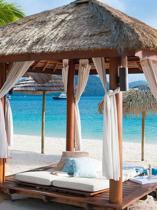 On the beach, white sand, sun loungers, beach umbrellas