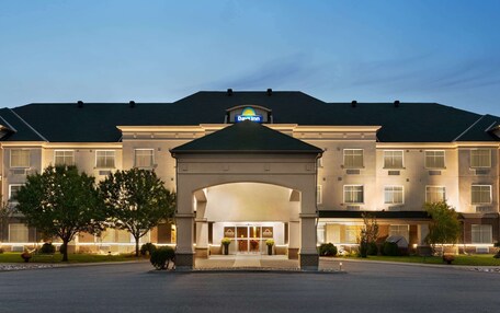 A Days Inn hotel with a large entrance, multiple windows, and a well-lit facade.