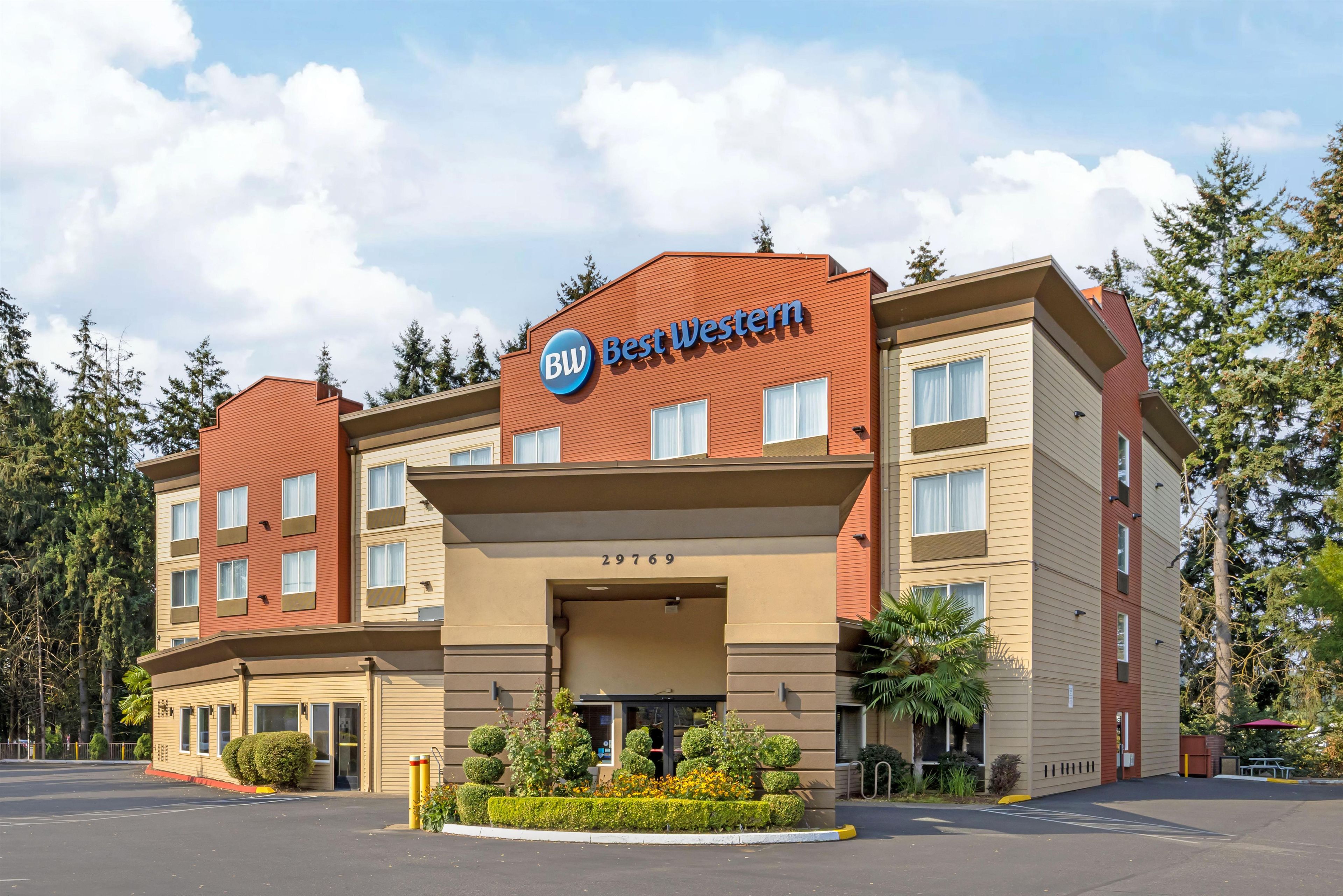 A hotel with a prominent 'Best Western' sign, a multi-story structure, and a parking lot.