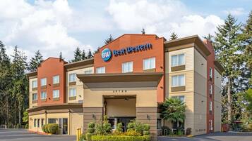 A hotel with a prominent 'Best Western' sign, a multi-story structure, and a parking lot.