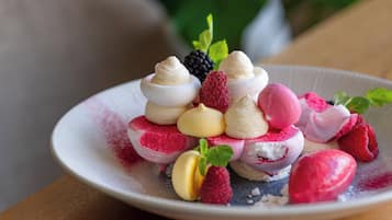 A dessert plate with various fruits and meringues.
