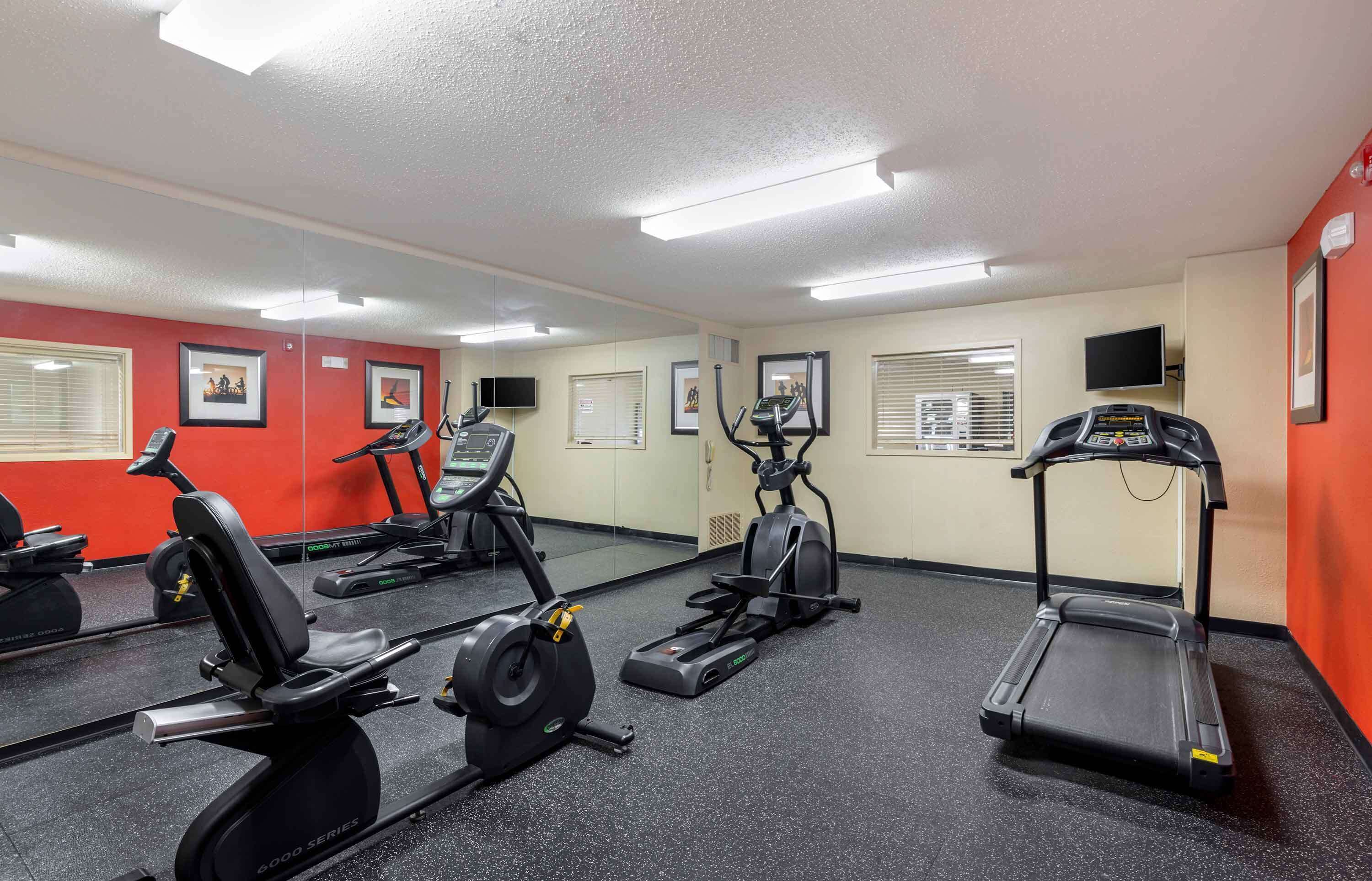 A gym with treadmills, stationary bikes, and elliptical machines.