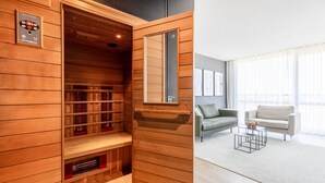 A sauna with wooden walls and shelves, a mirror, and a control panel.