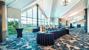 A spacious conference room with a long table, large windows, and a high ceiling. - Clarion Hotel & Conference Centre Abbotsford  (Abbotsford)