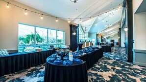 A banquet hall with long tables covered in black tablecloths, a chandelier, and string lights. - Clarion Hotel & Conference Centre Abbotsford  (Abbotsford)