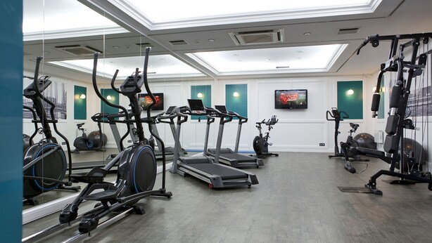 A gym with treadmills, stationary bikes, and weight machines. - Astoria Hotel Antwerp (Antwerp)