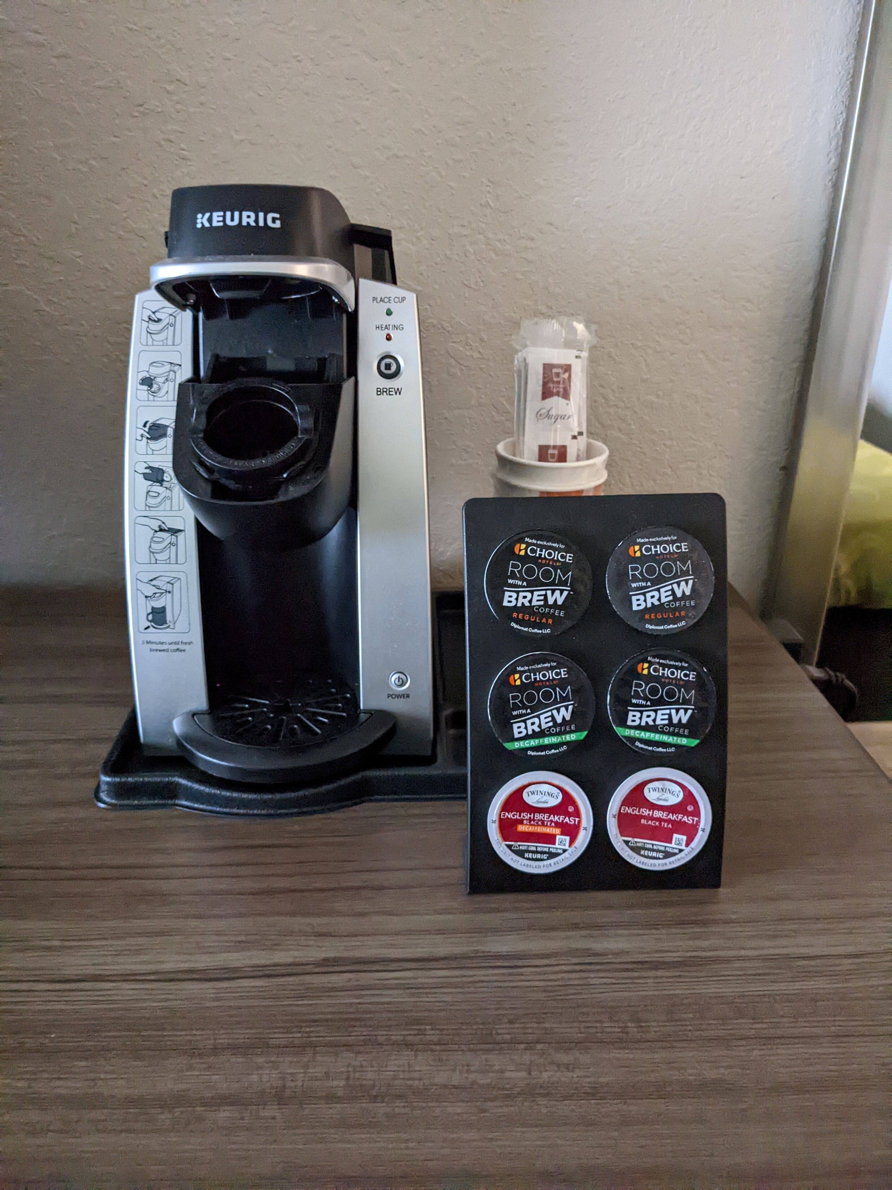 A Keurig coffee maker with a coffee pod holder displaying various coffee options.