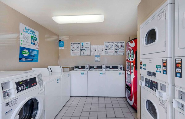Convenient laundry facilities offer self-service options with digital displays and multiple machines.