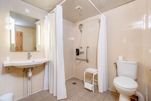 A bathroom with a sink, toilet, shower, and a mirror. - B&B HOTEL Orly Rungis Aéroport (Rungis)