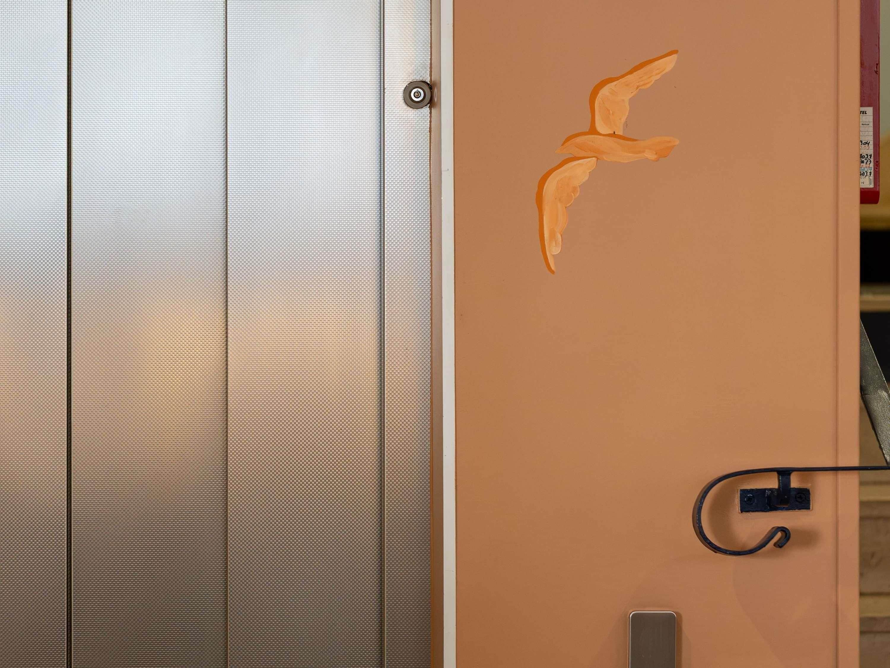 A door with a textured surface and a metal handle.