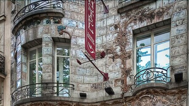 A historic building with ornate iron railings, large windows, and a prominent entrance. - Hotel Elysées Céramic (Paris)