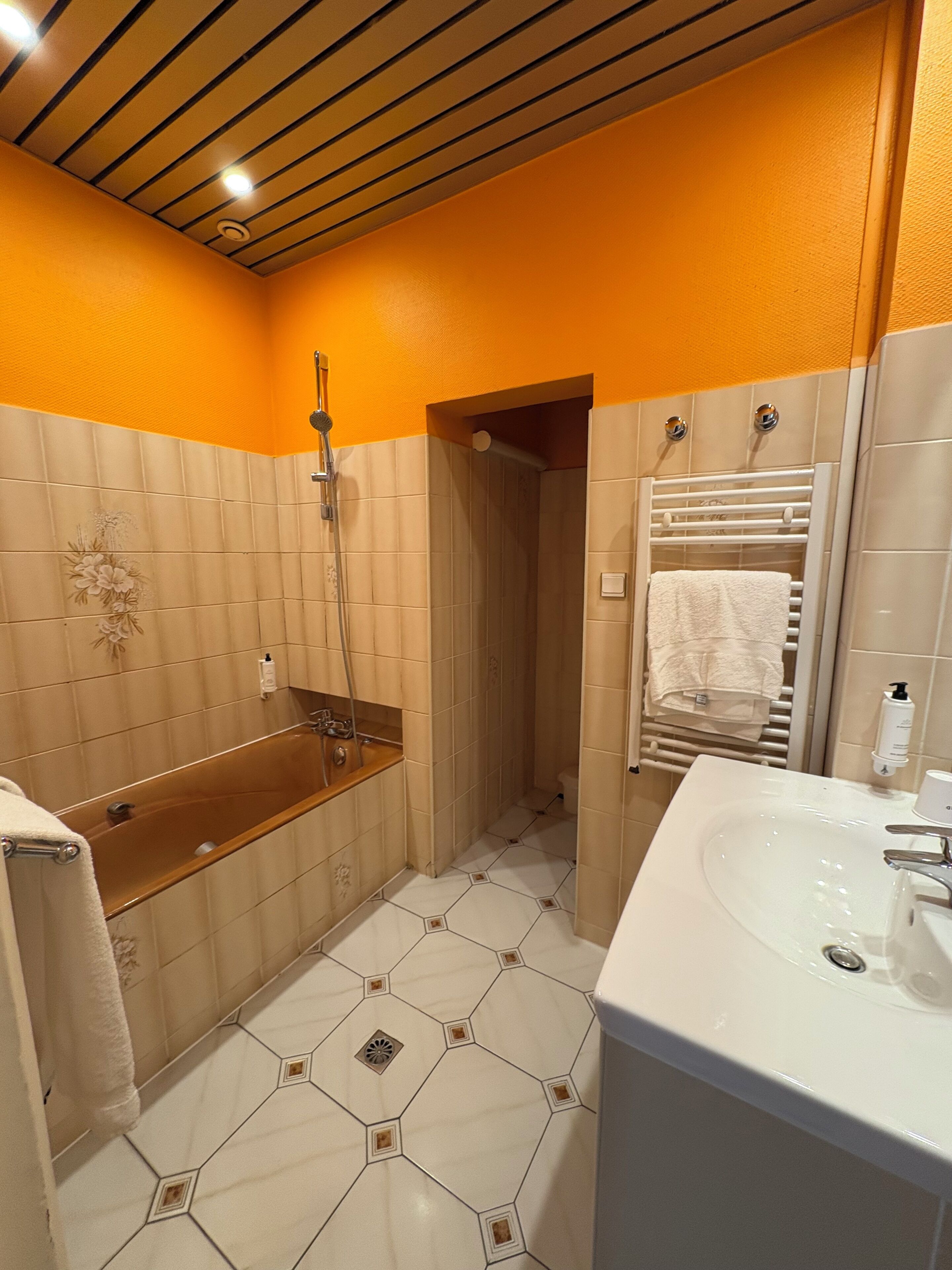 A bathroom with a bathtub, shower, and sink.